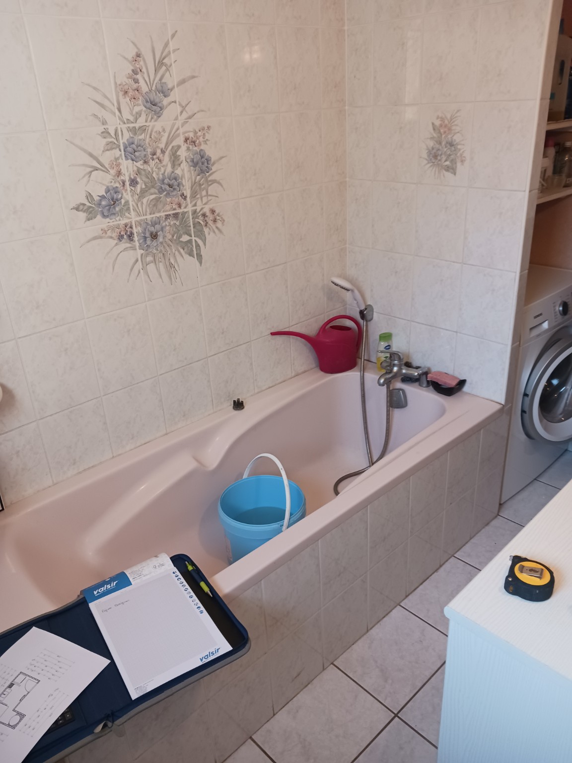 Salle de bains avec baignoire rose avant rénovation